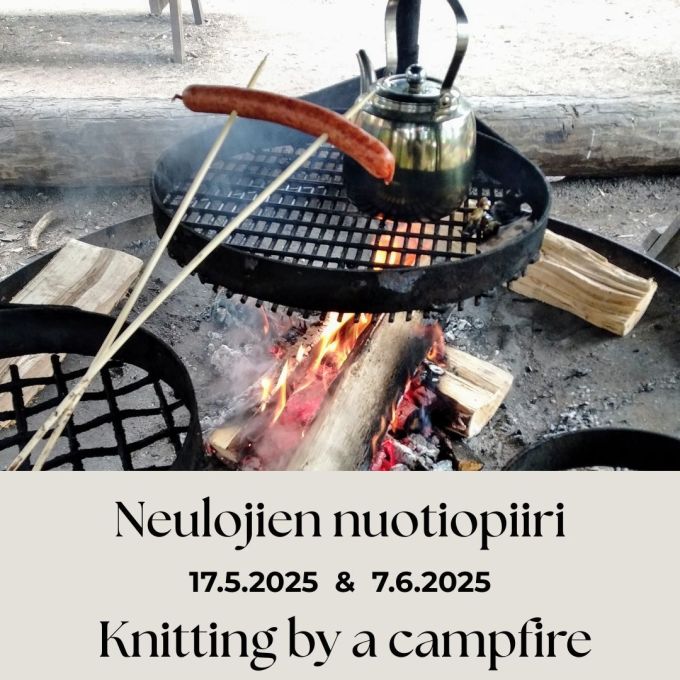 A picture of a burning campfire with a metal coffee pot overth flames and a sausage roasting on a stick.